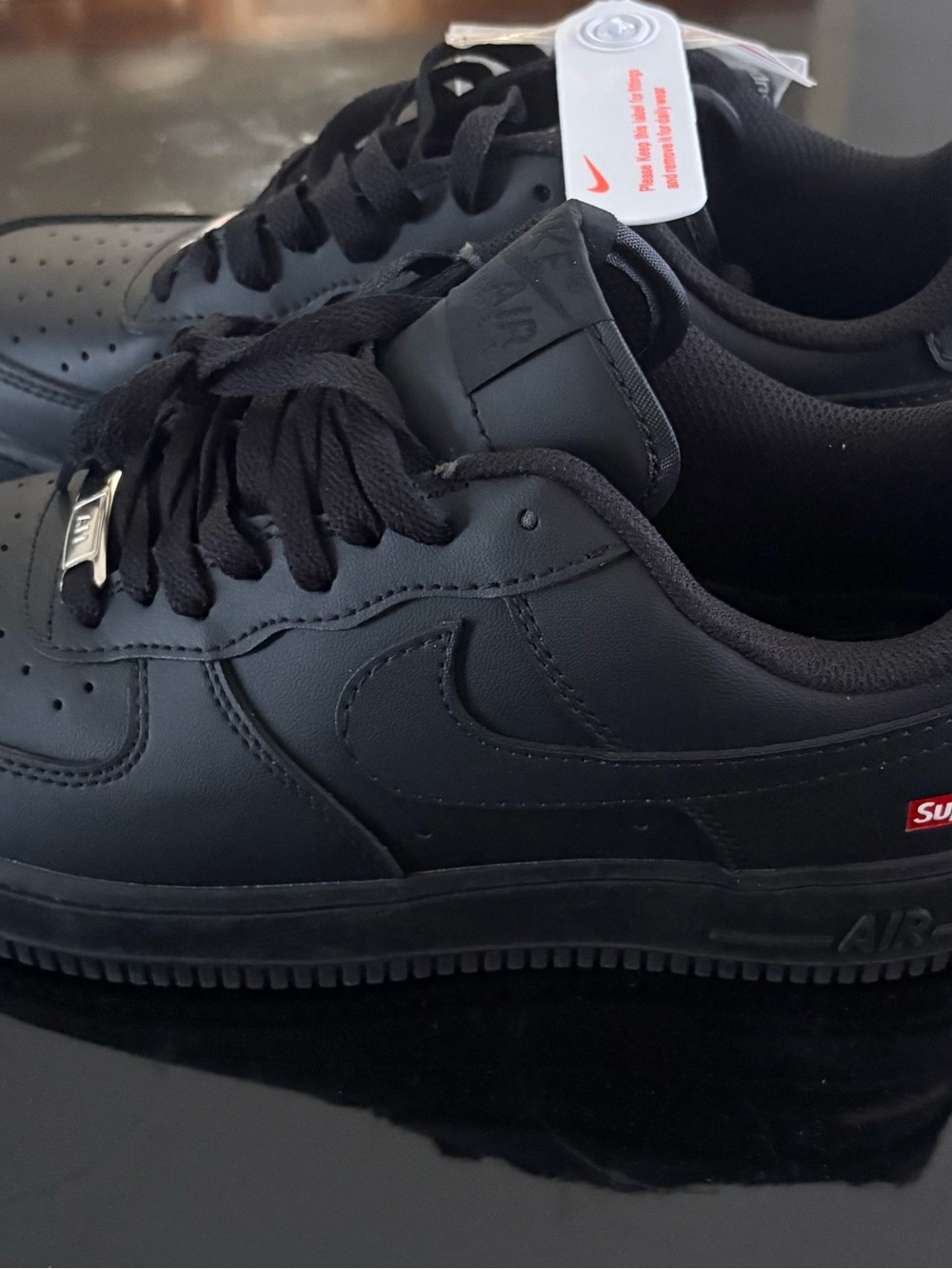 Nike Black Low-Top Leather Sneakers with Subtle Red Tab